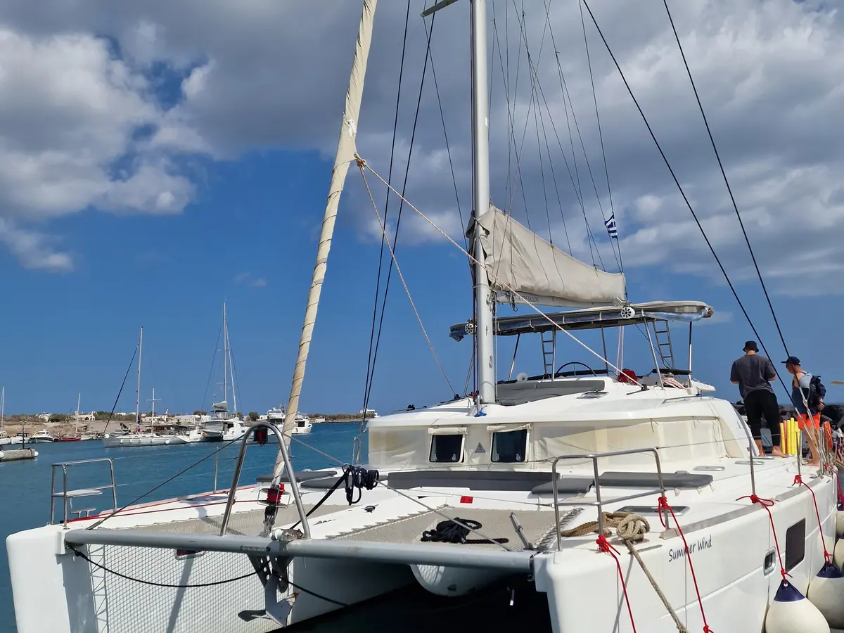 The catamaran’s deck at the berth before departure, other boats alongside.