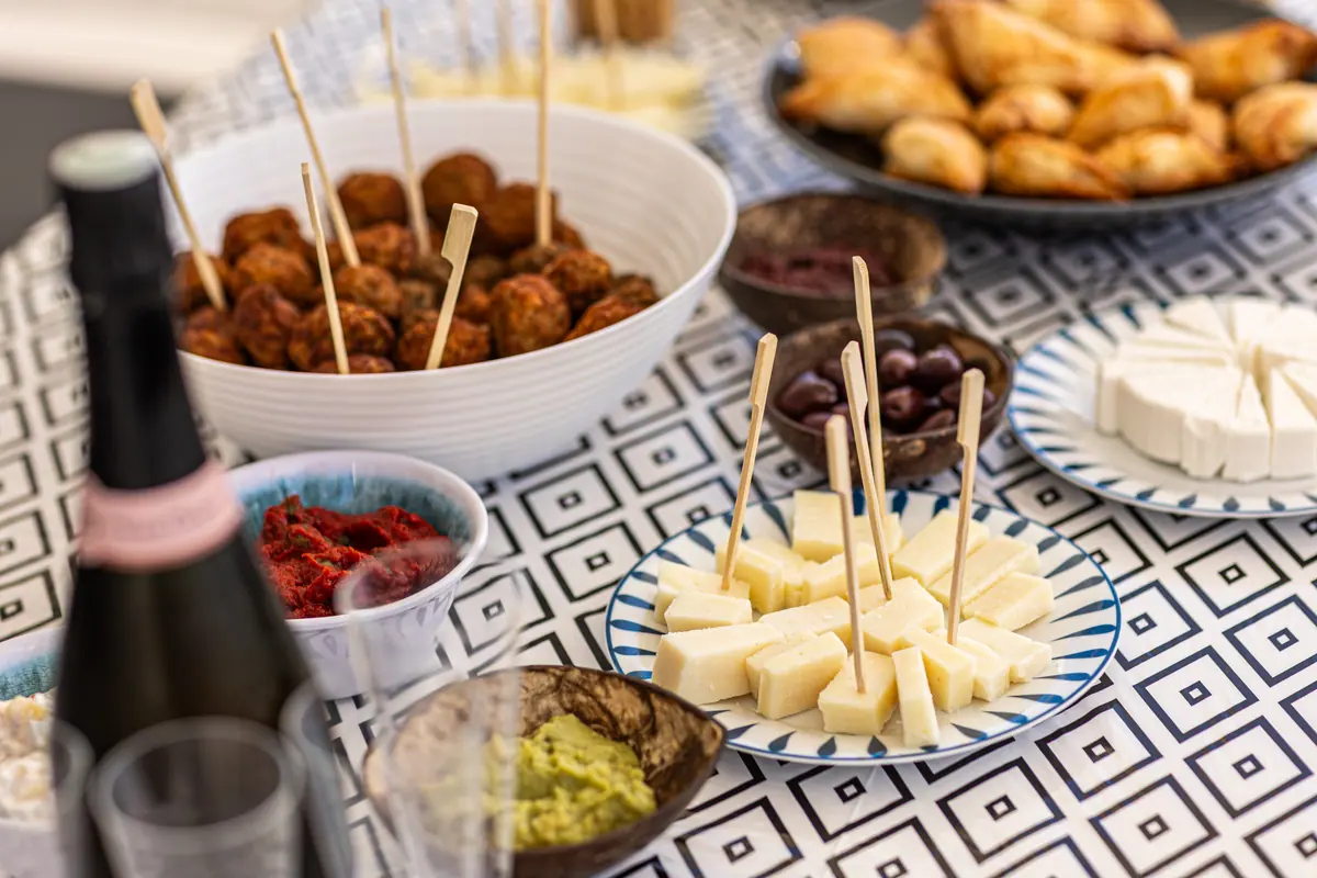 A close view of the meze on the table: meatballs, olives, cheese and pastries.