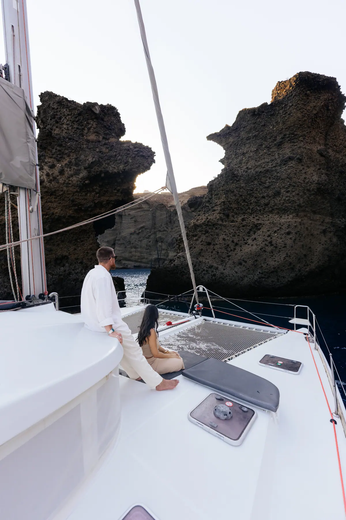 The rock formation close aboard, the gap worn through it open to the sky.
